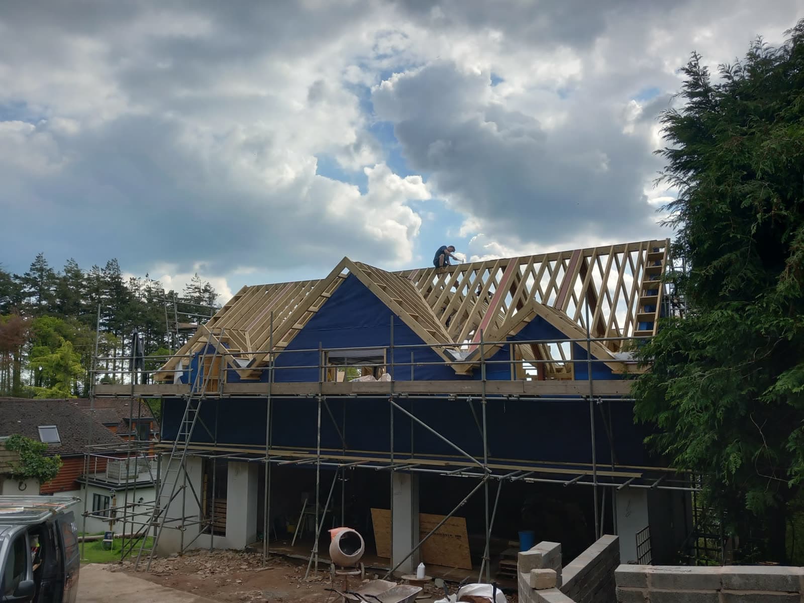 Cut roof carpentry with worker on the ridge